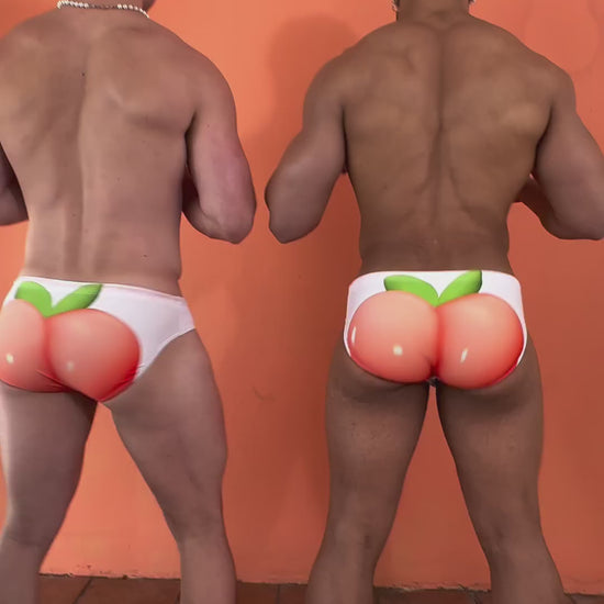 video of 2 guys showing off their peach swimwear and laughing